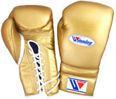 Metallic gold Winning professional lace-up boxing gloves featuring a premium leather finish and white laces at PunchPro Boxing.