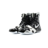 A pair of Custom Nike HyperKO boxing shoes in a black and silver colorway, featuring a forefoot lockdown strap and Nike Swoosh, displayed on a white background.