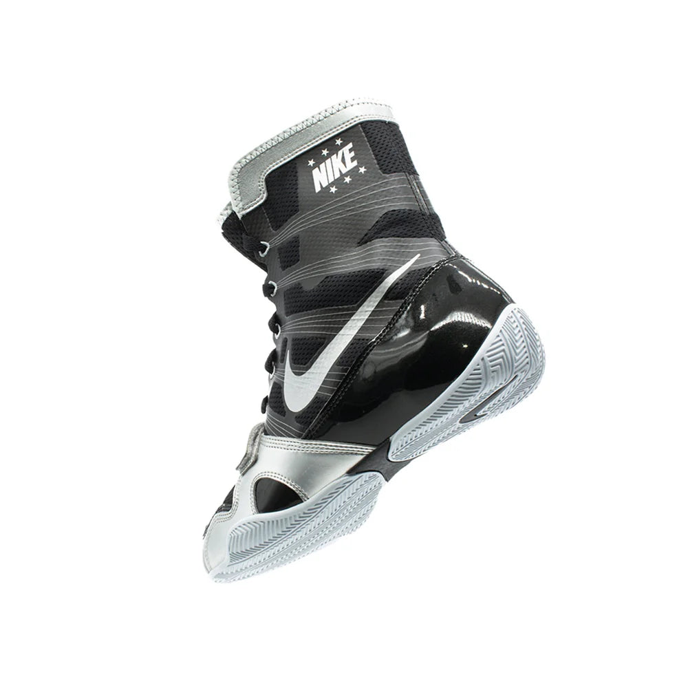 A pair of Custom Nike HyperKO boxing shoes in a black and silver colorway, featuring a forefoot lockdown strap and Nike Swoosh, displayed on a white background.