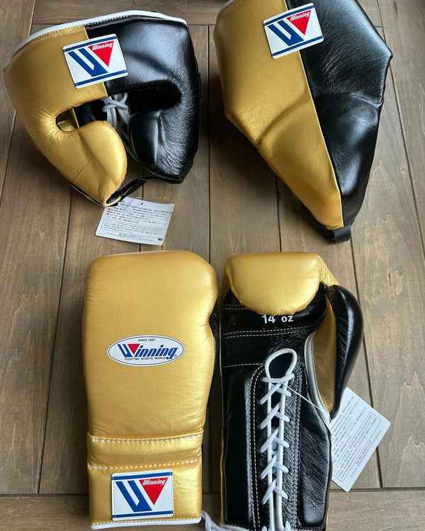 Complete Winning professional custom metallic gold and black training set featuring a 14 oz vertical split design on the lace-up gloves, face guard, and groin protector at PunchPro Boxing.