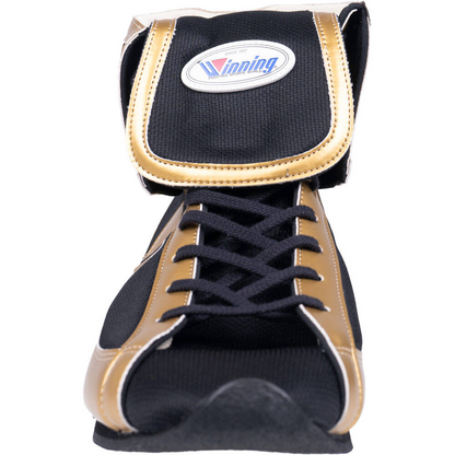 Black and gold boxing shoe close-up showing lacing and tongue detail