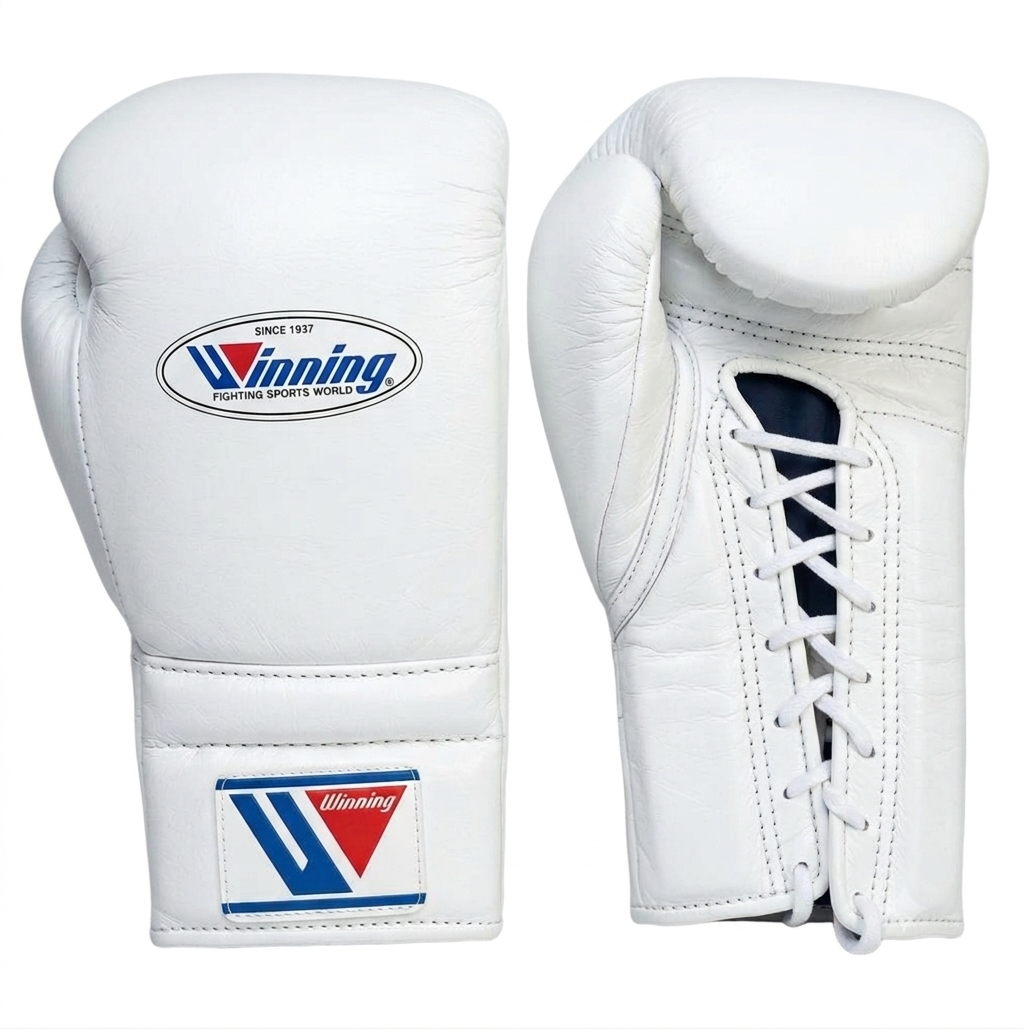 A pair of white leather boxing gloves shown from the front and side on a plain white background. The front glove features the Winning brand logo on the wrist strap and a larger oval logo on the back of the hand.