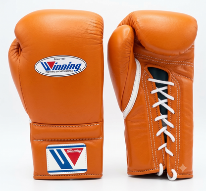 Gold and tan leather lace-up boxing training gloves from the sparring set