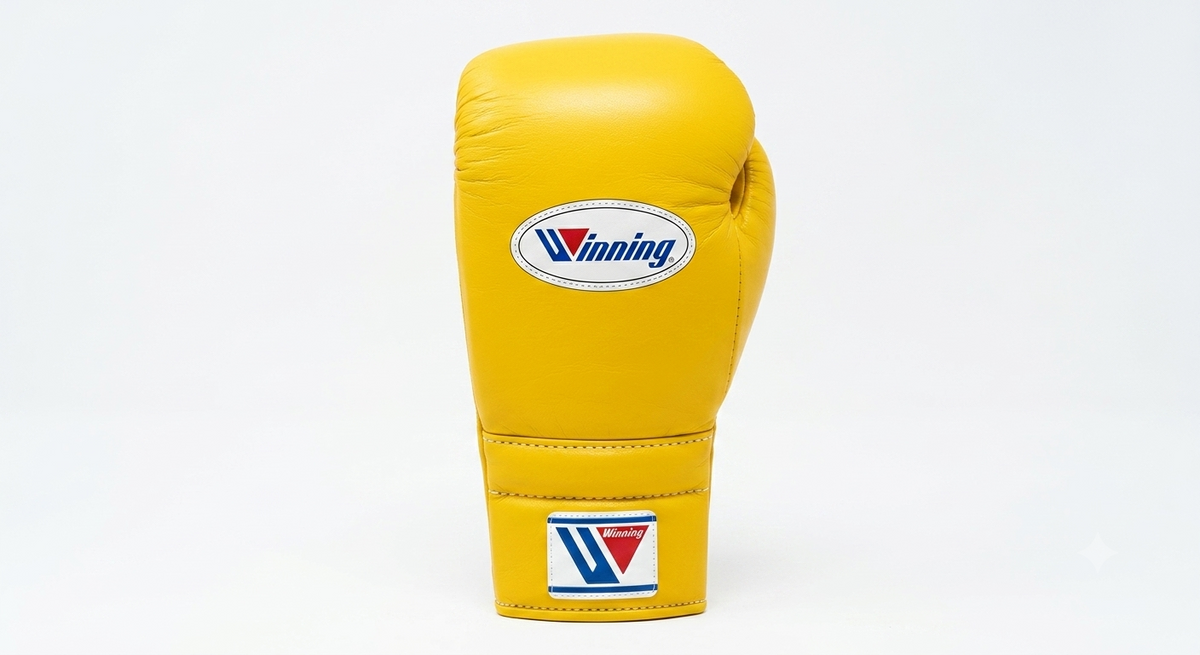 Classic yellow leather lace-up boxing training glove standing upright