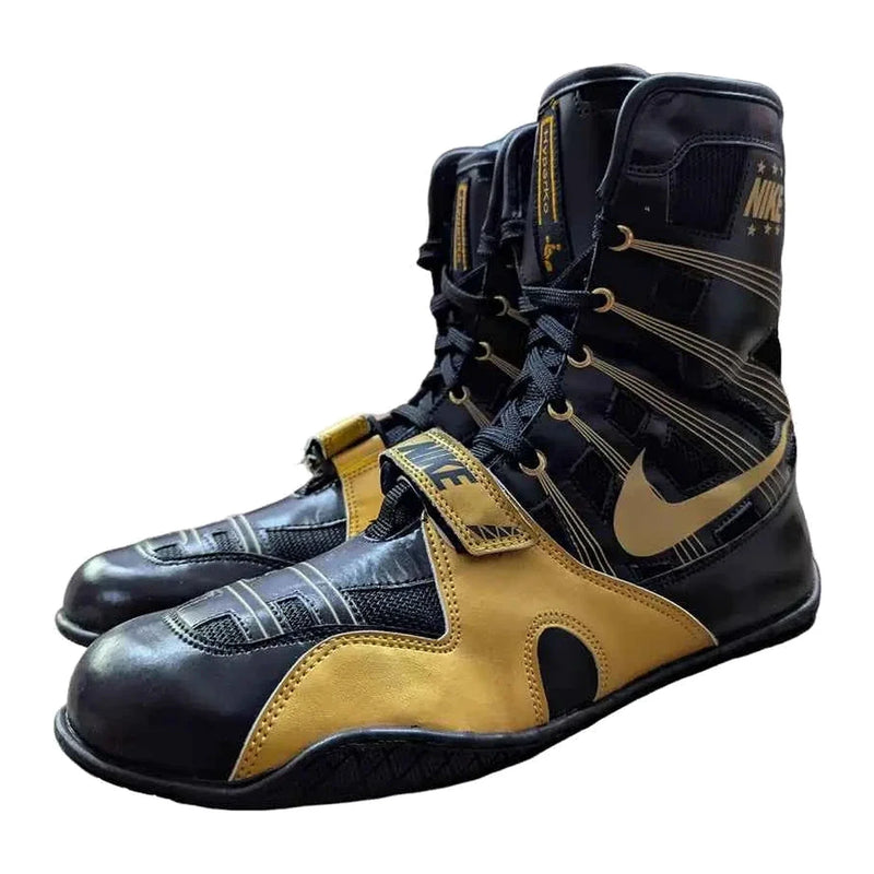 Nike high-top boxing shoes in black and gold with patterned upper, gold Swoosh and gold hook-and-loop strap