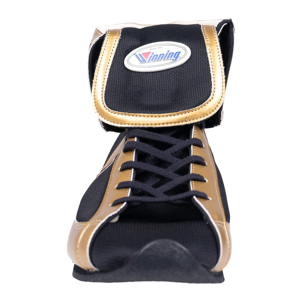 Black and gold boxing shoe close-up showing lacing and tongue detail